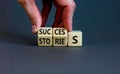 Success stories symbol. Businessman turns wooden cubes and changes the word stories to success. Beautiful grey table, grey