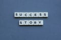 ' Success Story ' word made of square letter word on grey background