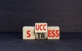 Success or stress symbol. Concept word Success Stress on wooden cubes. Beautiful black table black background. Business and Royalty Free Stock Photo