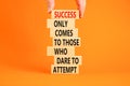 Success symbol. Concept words Success only comes to those who dare to attempt on wooden blocks. Beautiful orange background copy
