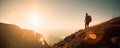 Success symbol. Silhouette of a woman hiking in the mountains at sunset with sun flare. Happiness and freedom concept. Generative Royalty Free Stock Photo