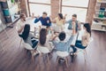 Success and team work concept. Top up of team of business partners with raised up hands in light modern workstation, celebrating Royalty Free Stock Photo