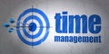 Time concept: target and Time Management on wall background