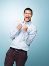 Success is very becoming for a young man. Shot of a young man shouting in joy against a studio background. Royalty Free Stock Photo