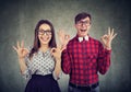 Young funny couple showig ok sign expressing excitement