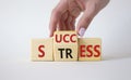 Success vs Stress symbol. Businessman hand turns wooden cubes and changes the word Stress to Success. Beautiful white background. Royalty Free Stock Photo