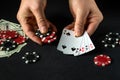 Success in winning in the hands of a player at a black table in a poker club with a combination four of a kind or quads