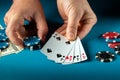 Success in winning in the hands of a player at a blue table in a poker club with a combination four of a kind or quads