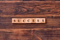 Success word lettering made of wooden cubes on dark rustic wooden background. Business, achievement, ambition, success and winning Royalty Free Stock Photo