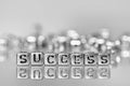 Success word written on grunge silver cube with black and white Royalty Free Stock Photo