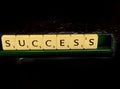 Success word written on scrabble blocks for content creation