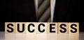 Success word written on wood block. Success text on wooden table for your desing