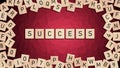 Success word written with wooden tiles over red background