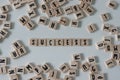 Success written in wooden letter tiles on a white background