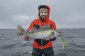 Success zander fishing. Happy fisherman with big walleye fish trophy at lake Royalty Free Stock Photo