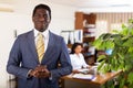 Successful african american businessman standing in office interior Royalty Free Stock Photo