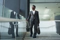 Successful African American Businessman Walking in Office Lobby Royalty Free Stock Photo
