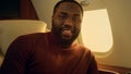 Successful african american guy traveling plane closeup. Smiling bearded man