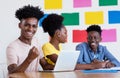 Successful african american male student at computer with group of students Royalty Free Stock Photo