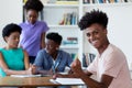 Successful african american male student learning at desk at school Royalty Free Stock Photo