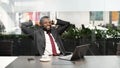 Successful african american manager sitting in front of notebook Royalty Free Stock Photo