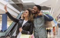 Successful african couple making selfie after shopping in mall Royalty Free Stock Photo