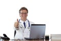 Successful aged doctor at desk holding thumb up Royalty Free Stock Photo