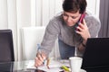 Successful agent business woman taking notes while talking on the smart phone Royalty Free Stock Photo