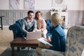 Successful agent giving consultation to family couple about buying house. Royalty Free Stock Photo