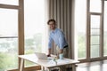 Successful, ambitious young businessman posing for corporate photo at workplace