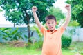 Successful Asian boy punching the air with his fists in air, smi