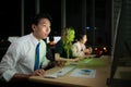 Successful asian business people celebrating success in office at night, Royalty Free Stock Photo