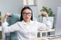 Successful Asian business woman looking at the camera and holding her hands up, a gesture of super power and success, an Royalty Free Stock Photo