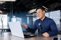 Successful Asian businessman mentor recording audio podcast, man in office using professional microphone for online Royalty Free Stock Photo