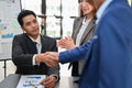 Successful Asian businessman shaking hand with his business partner after the meeting Royalty Free Stock Photo