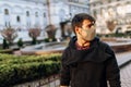 Successful asian businessman walking in the street, holding a laptop in his hand. Walks down the street in a mask Royalty Free Stock Photo