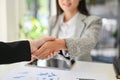 Successful Asian businesswoman shaking hand with her colleague or business partner. close-up Royalty Free Stock Photo