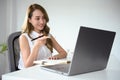 Successful Asian female manager looking some details at her laptop screen Royalty Free Stock Photo