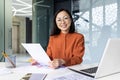 Successful Asian woman doing paperwork inside the office, businesswoman holding documents, reports and papers in her Royalty Free Stock Photo