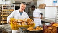 Successful baker during daily work in bakeshop