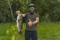 Successful bass fishing. Smiling bearded fisherman in sunglasses with bass fish show thumb up Royalty Free Stock Photo