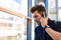 Successful bearded male CEO in formal suit phoning via cell telephone Royalty Free Stock Photo