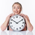 Successful beautiful young blond woman leaning on a clock