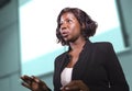 Successful black African American business woman with headset speaking in auditorium at corporate training event or seminar giving Royalty Free Stock Photo