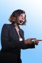 Successful black afro American business woman with headset speaking in auditorium at corporate training event or seminar giving Royalty Free Stock Photo