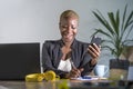 Successful black afro American business woman working at modern office with mobile phone writing notes on notepad Royalty Free Stock Photo