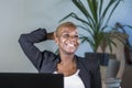 Successful black afro American business woman working at modern office smiling cheerful leaning relaxed on chair Royalty Free Stock Photo