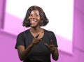 Successful black afro American entrepreneur woman with headset speaking in auditorium at corporate training event or seminar Royalty Free Stock Photo