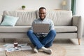 Successful Black Millennial Man Using Laptop Working Online At Home