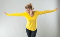 Successful blond woman smiling with arms opened for theatre gesture